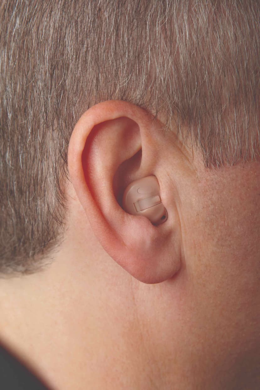 Close-up of a person's ear wearing an ITC hearing aid in the lower bowl